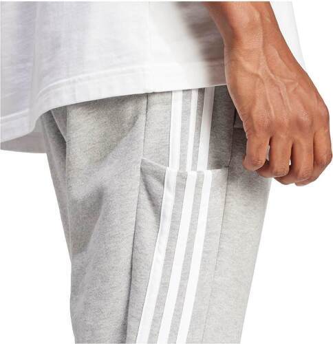 adidas Sportswear-Pantalon fuselé en molleton aux chevilles élastiques et à 3 bandes Essentials -1